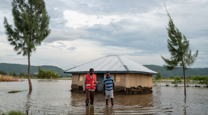 A Kenyan Red Cross worker speaks with a young man after visiting his flooding home in Nyondo, Kisumu County, Kenya, Monday, Dec 16, 2019. Heavy rains have hit Kenya particularly hard this year, killing crops and displacing tens of thousands of people throughout the country. Mackenzie Knowles-Coursin/ICRC