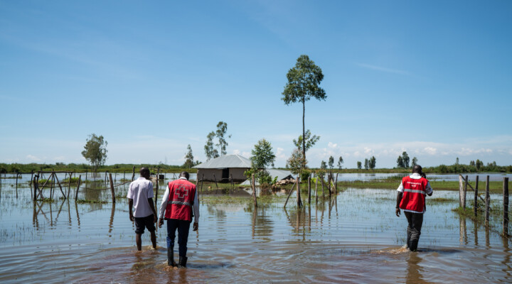 Red Cross workers wade through water to inspect flooded houses in Osodo, Homa Bay, Kenya, Tuesday, Dec 17, 2019. Heavy rains have hit Kenya particularly hard this year, killing crops and displacing tens of thousands of people throughout the country.  Mackenzie Knowles-Coursin/ICRC