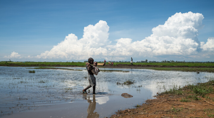 A boy carries his younger sister through some of the flood waters that have inundated much of Kisumu County, Kenya, Monday, Dec 16, 2019. Heavy rains have hit Kenya particularly hard this year, killing crops and displacing tens of thousands of people throughout the country. Mackenzie Knowles-Coursin/ICRC