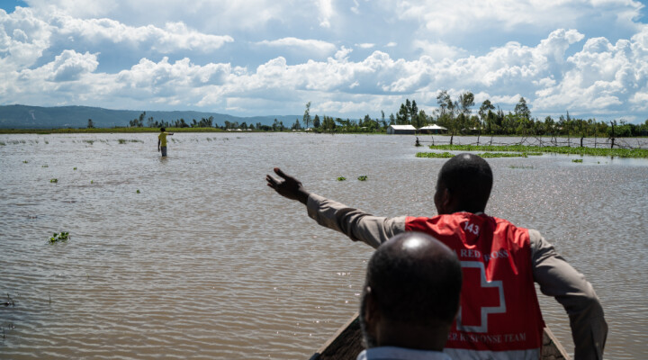 A Kenyan Red Cross worker points out crop land that has been devastated by recent flooding in West Nykach, Kisumu County, Kenya, Monday, Dec 16, 2019. Heavy rains have hit Kenya particularly hard this year, killing crops and displacing tens of thousands of people throughout the country. Mackenzie Knowles-Coursin/ICRC