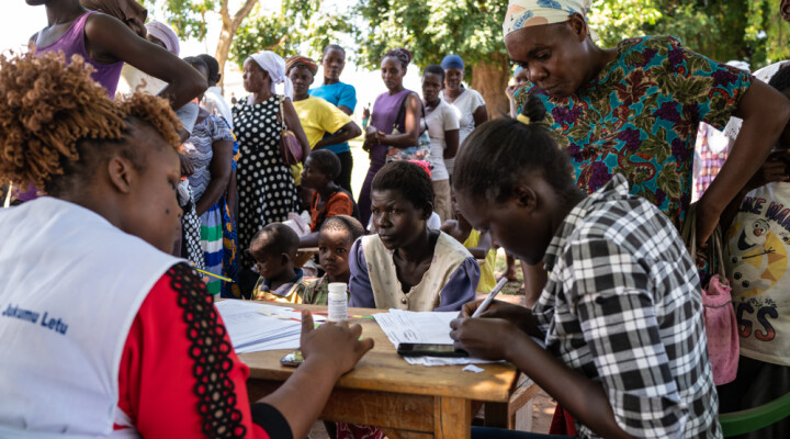 : Women and children displaced by flooding speak with nurses at a pop-up medical clinic organized by Kenyan Red Cross in Osodo, Homa Bay, Kenya, Tuesday, Dec 17, 2019. Heavy rains have hit Kenya particularly hard this year, killing crops and displacing tens of thousands of people throughout the country. Mackenzie Knowles-Coursin/ICRC