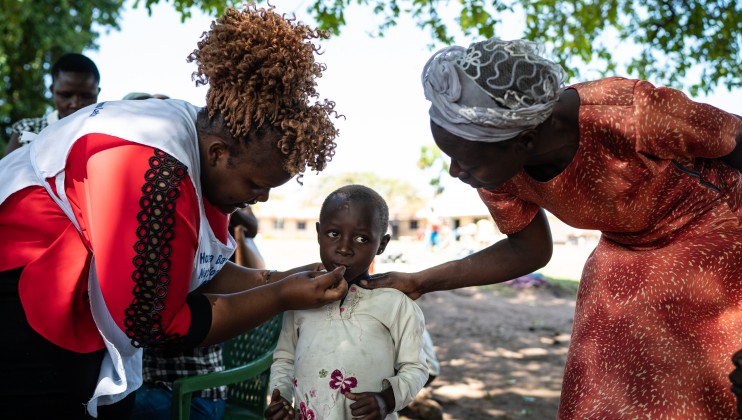 A young girl displaced by flooding is given medicine at a pop-up medical clinic organized by Kenyan Red Cross in Osodo, Homa Bay, Kenya, Tuesday, Dec 17, 2019. Heavy rains have hit Kenya particularly hard this year, killing crops and displacing tens of thousands of people throughout the country. Mackenzie Knowles-Coursin/ICRC