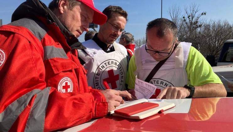 Ukrainian Red Cross and ICRC staff finalize details from a distribution that took place on March 26, 2022 in Kharkiv, Ukraine. A convoy carrying 60 tons of food and non-food items delivered the aid to a URCS warehouse where it would be further distributed to people affected by the conflict in the area.
