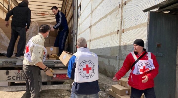 Ukrainian Red Cross and ICRC staff unload goods from trucks at the URCS warehouse in Kharkiv, Ukraine March 26, 2022. A ICRC convoy carrying 60 tons of food and non-food items unloaded the aid at a URCS warehouse where it will be further distributed by the URCS to people affected by the conflict.