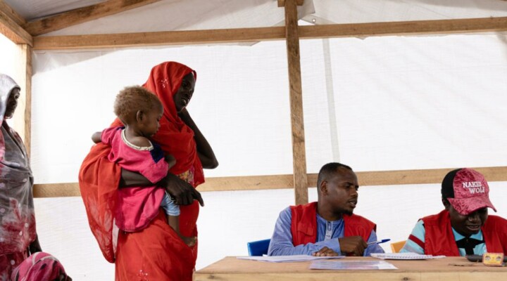 Sudanese refugees in Adre using free phone calls provided by the ICRC and Chadian Red Cross to contact their family